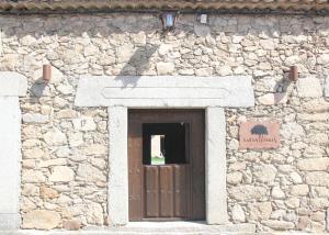 a cross on the side of a stone building at La Centenaria de Alaraz in Alaraz