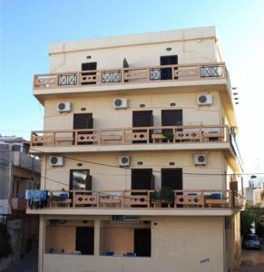 a tall building with a balcony on top of it at Minos Studios in Chania