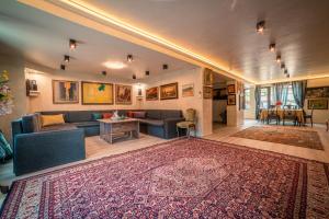 a living room with a couch and a rug at The Gallery Guest House - Garden and Garage in Veliko Tŭrnovo