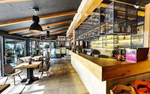 a restaurant with a bar with tables and chairs at Rooms Bolero Naklo in Naklo