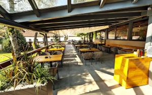an outdoor patio with tables and chairs and a restaurant at Rooms Bolero Naklo in Naklo