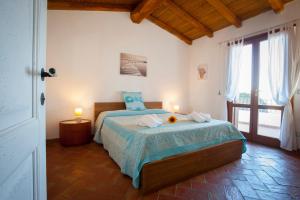 a bedroom with a bed with two candles on it at Villa Isuledda Lux in San Teodoro +82 photos