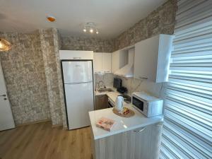 a kitchen with a white refrigerator and a microwave at King Suite BH37 in Istanbul