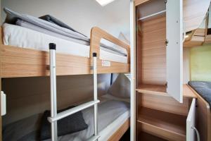 a small room with two bunk beds in a caravan at Ferienanlage Kirchzarten in Kirchzarten