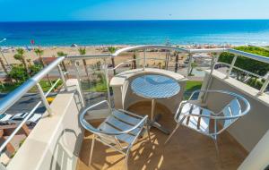 a balcony with a table and chairs and the beach at Kleopatra Celine Hotel in Alanya