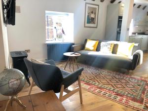 a living room with a couch and a table at 3 The Olde Barn Apartments in Stamford