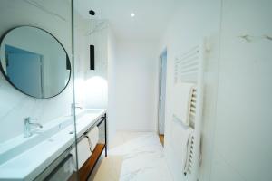 a bathroom with a mirror and a sink at B&B La Maison Galiène in Bordeaux +52 photos