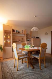 a kitchen with a wooden table and two chairs at Ferienhaus Schaumbergblick in Britten