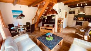 a living room with a couch and a table at Ferienhaus-Maxe-Haus-Paula in Wulfen auf Fehmarn