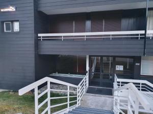 a building with a balcony and stairs in front of it at Chamrousse 1750 Roche Béranger 50m2 4-6pers Vue panoramique in Chamrousse