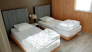 A bed or beds in a room at L'écrin des Vosges