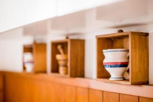 a row of shelves with vases on a shelf at Lotus Oasis I Nature Experience in Torre