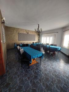 a dining room with blue tables and chairs at Pensiunea Mariana in Bran