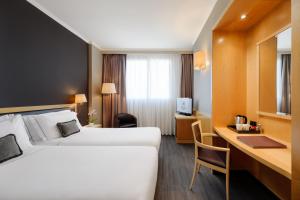 a hotel room with a bed and a desk at City Life Hotel Poliziano, by R Collection Hotels in Milan