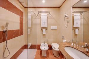 a bathroom with a toilet, sink, and bathtub at City Life Hotel Poliziano, by R Collection Hotels in Milan