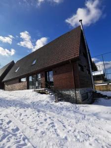 a log cabin in the snow with snow at CASA SMIDA ACTIV in Smida