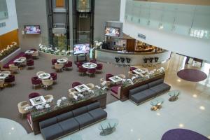 an overhead view of a hotel lobby with tables and chairs at Omega Sirius in Adler