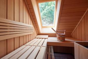 a sauna with wooden benches and a window at Hotel & Restaurant Linde in Münstertal