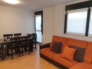 a living room with a couch and a dining room at Apartamento Vive Jaca in Jaca