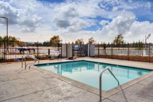 a swimming pool with an iron fence and a fence at Wyndham Garden Sacramento Airport Natomas in Sacramento