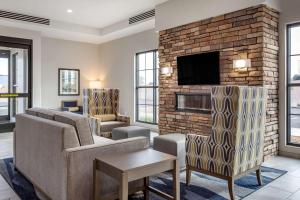 a living room with couches and a fireplace at Comfort Suites Scottsdale Talking Stick Entertainment District in Scottsdale