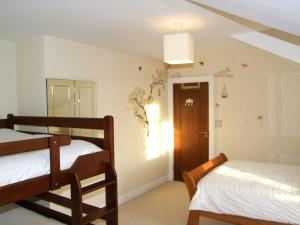 a bedroom with two bunk beds and a window at Glendalough 10 Minutes from Beautiful Farmhouse in Roundwood
