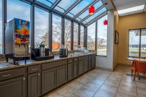 a large kitchen with a counter with windows at Super 8 by Wyndham Perrysburg-Toledo in Perrysburg