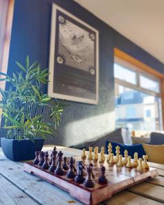 a wooden chess board with chess pieces on a table at Ocean Surf lodge in Newquay