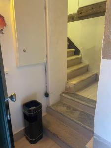 a hallway with stairs with a trash can at Dimora Blu Suite in Venice