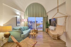 a living room with a blue couch and a swing at weforyou Isla Puerto Marina with PARKING in Benalmádena