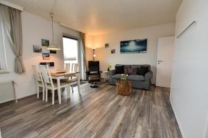 a living room with a table and a couch at Haus "Najade" Appartement NAJA8 in Döse