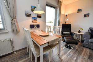 a kitchen and dining room with a table and chairs at Haus "Najade" Appartement NAJA8 in Döse