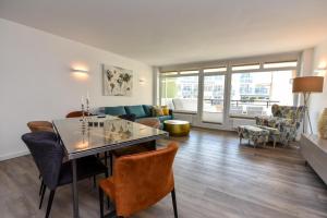 a living room with a table and a couch at Haus "Panorama" Appartement PAN022 in Duhnen