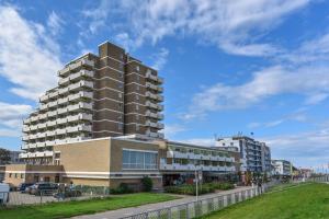 a large apartment building with a tall building at Haus "Panorama" Appartement PAN024 in Duhnen
