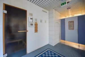 a hallway with a door in a room with a tile floor at Haus "Panorama" Appartement PAN087 in Duhnen