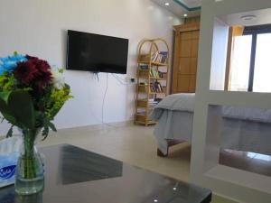 a living room with a vase of flowers on a table at The view studio in Hurghada