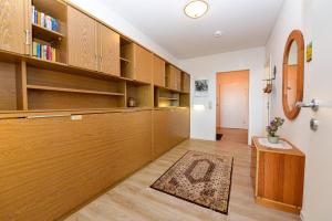 a room with wooden cabinets and a hallway with a rug at Haus "Panorama" Appartement PAN096 in Duhnen