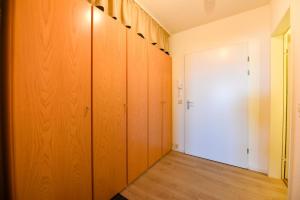 a hallway with wooden lockers and a white door at Haus "Panorama" Appartement PAN096 in Duhnen +17 photos