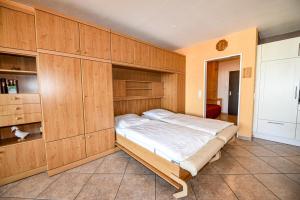 a bedroom with a large bed with wooden cabinets at Haus "Panorama" Appartement PAN102 in Duhnen +17 photos