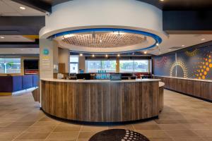 a lobby with a bar in a hospital at Tru By Hilton Comstock Park Grand Rapids, MI in Comstock Park