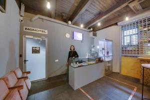 a woman standing at the counter of a restaurant at MOONOTEL Maidan in Kyiv