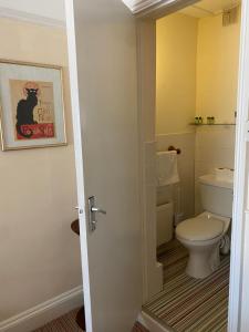 a bathroom with a toilet and a sink at The Durbeyfield Guest House in West Bay
