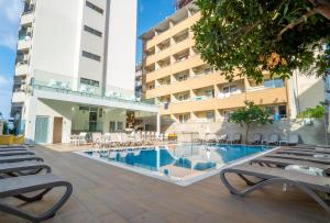 a swimming pool in front of a building at Kleopatra Celine Hotel in Alanya
