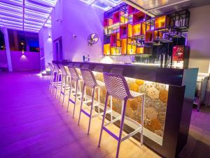 a bar with chairs lined up at a bar at Kleopatra Celine Hotel in Alanya