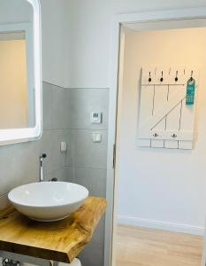 a bathroom with a white sink and a mirror at Ankerplatz Timmendorfer Strand in Timmendorfer Strand