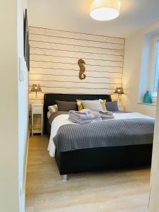a bedroom with a large bed with a wooden headboard at Ankerplatz Timmendorfer Strand in Timmendorfer Strand