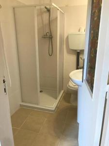 a bathroom with a shower and a toilet at Lagos City Center Rooms in Lagos