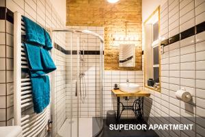 a bathroom with a shower and a sink at BpR Whistle Arts Industrial Apartment in Budapest +36 photos