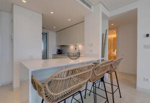 a kitchen with a counter and chairs in a room at Luxury apt in the hills of Marbella in Ojén