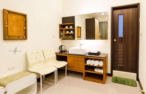 a bathroom with a sink and a vanity with a mirror at Tainan Yi Zhan in San-fen-tzu
